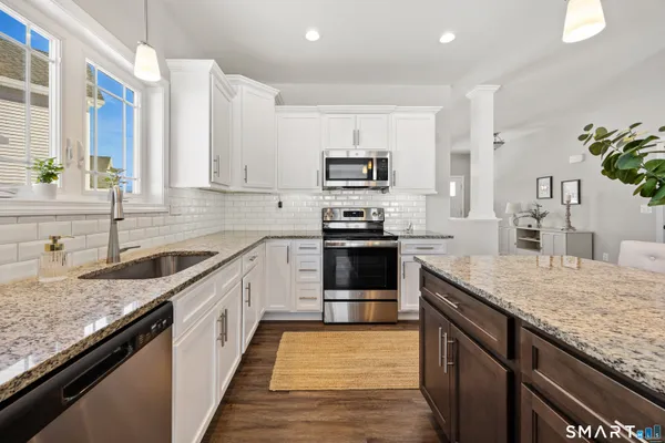a kitchen with stainless steel appliances granite countertop a sink and stove
