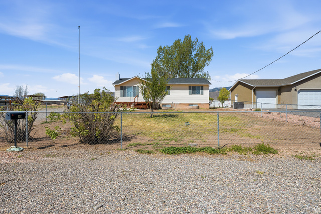 337 North Main Street Central Valley, UT 84754 - Photo 2 of 40 View of front of house with a fenced front yard and a garage