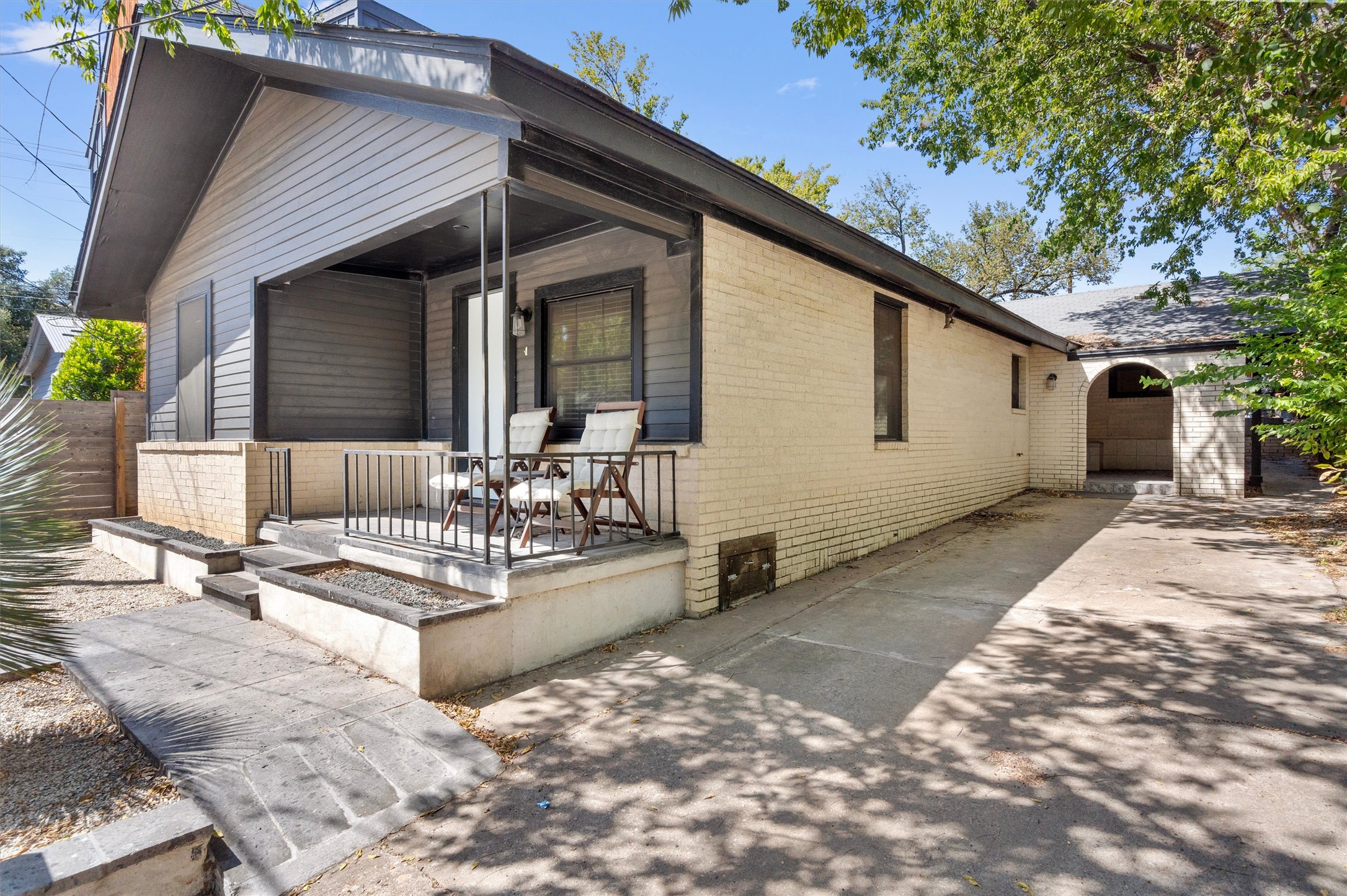 An inviting front porch with brick and siding accents details this classic single-story home.