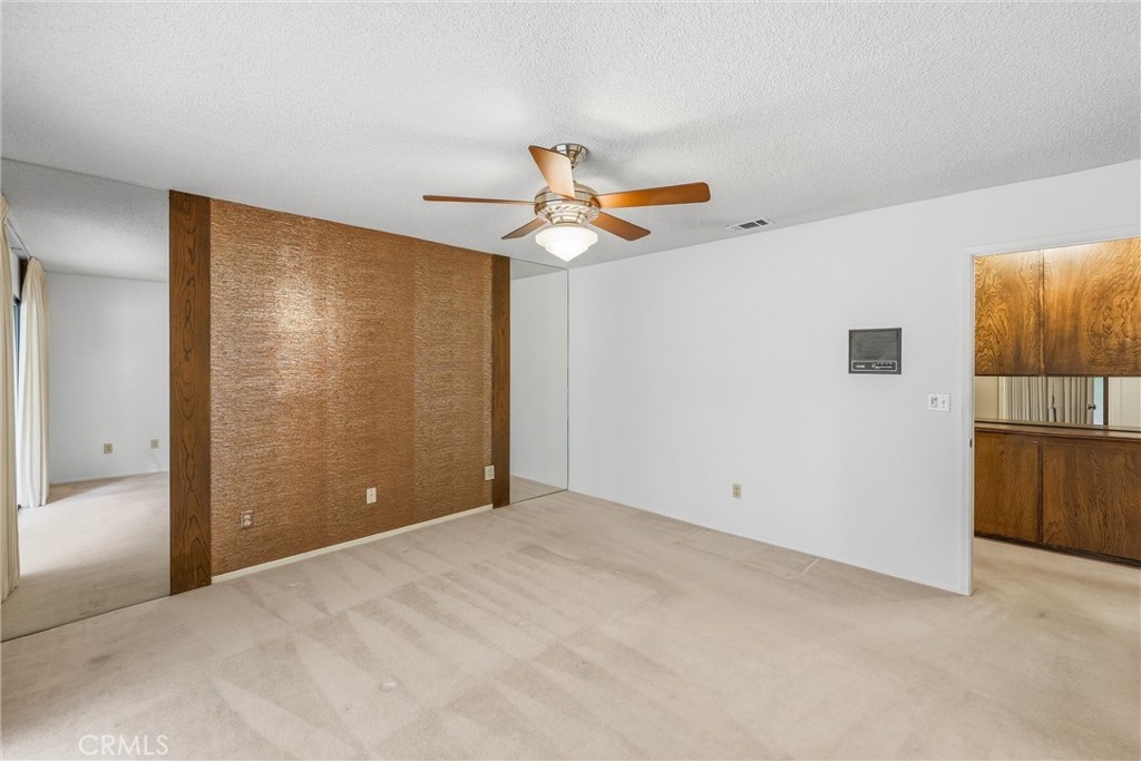 37295 Oak View Road Yucaipa, CA 92399 - Photo 31 of 59 a view of a big room with closet and a chandelier fan