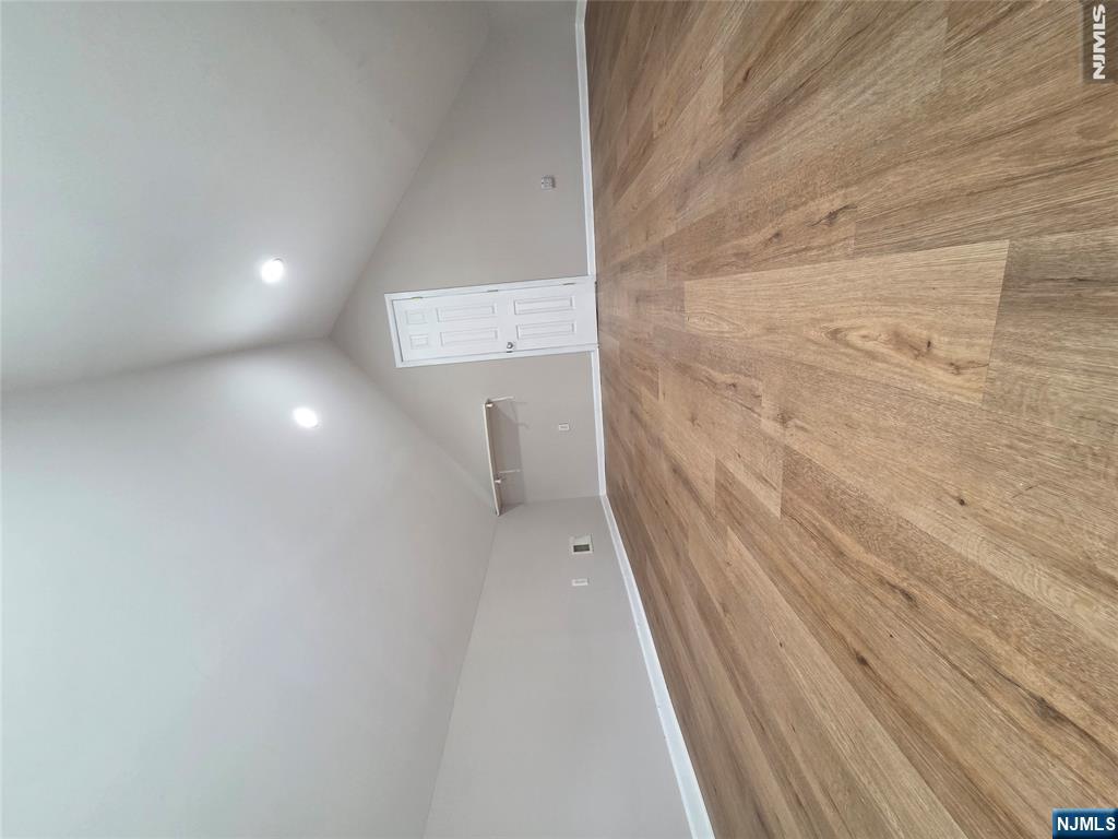 22 Broadway, Unit 2 Hackensack, NJ 07601 - Photo 11 of 11 an empty room with wooden floor and windows
