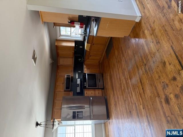 22 Broadway, Unit 2 Hackensack, NJ 07601 - Photo 4 of 11 a kitchen with kitchen island a stove a sink and a refrigerator