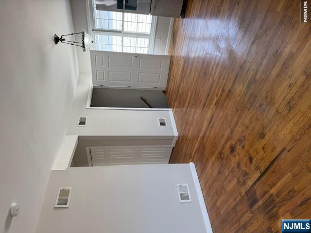 22 Broadway, Unit 2 Hackensack, NJ 07601 - Photo 5 of 11 a view of an empty room with window and wooden floor