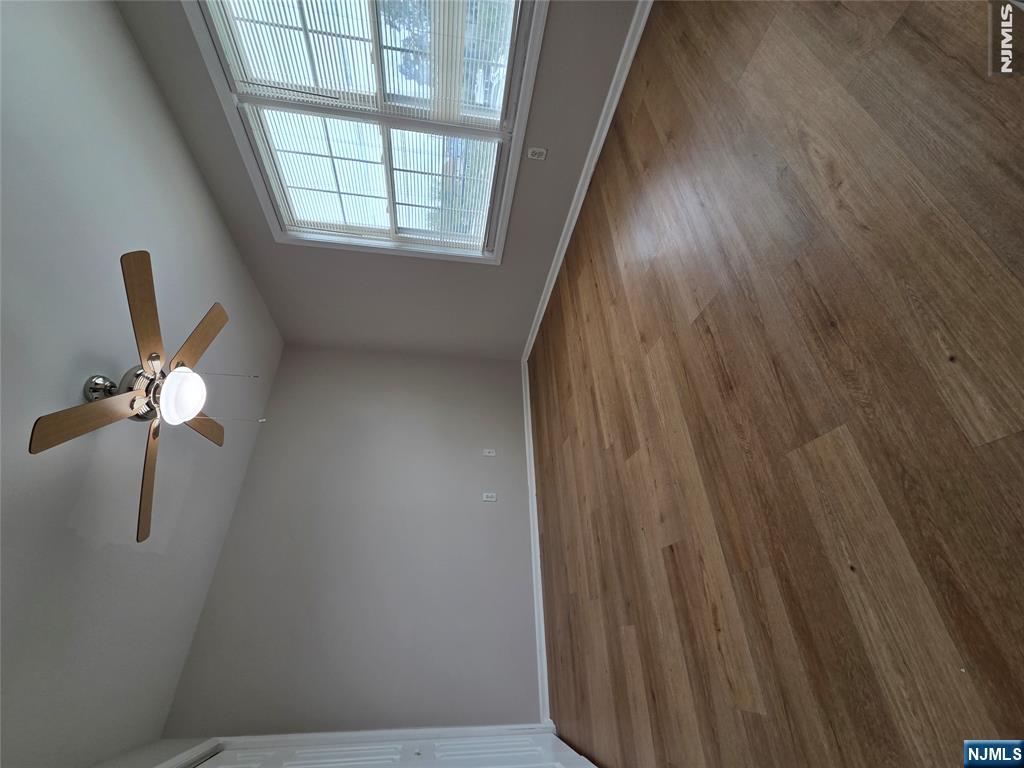 22 Broadway, Unit 2 Hackensack, NJ 07601 - Photo 8 of 11 an empty room with wooden floor and windows