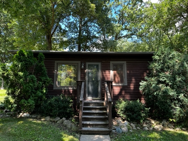 a front view of a house with plants