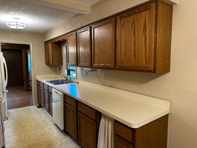 27678 West Stonegate Drive Spring Grove, IL 60081 - Photo 4 of 20 a kitchen with kitchen island granite countertop wooden cabinets and sink