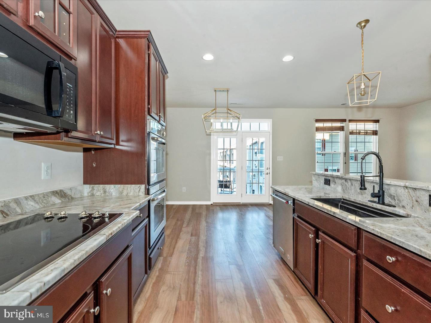 208 B Mill Pond Road Frederick, MD 21701 - Photo 14 of 45 a kitchen with stainless steel appliances granite countertop a sink stove and wooden floor
