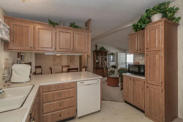 a kitchen with stainless steel appliances granite countertop a refrigerator sink and cabinets