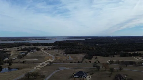 an aerial view of a backyard with chairs