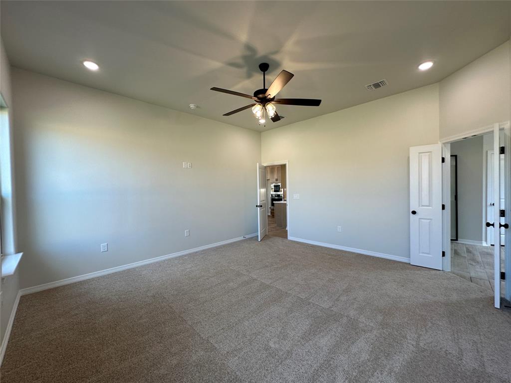 403 Rusty Spur Lorena, TX 76655 - Photo 19 of 29 a view of an empty room with a ceiling fan