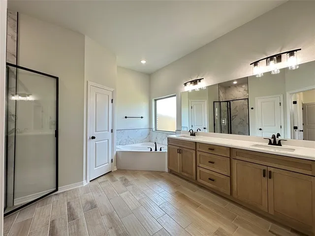 a large bathroom with a large mirror vanity and shower