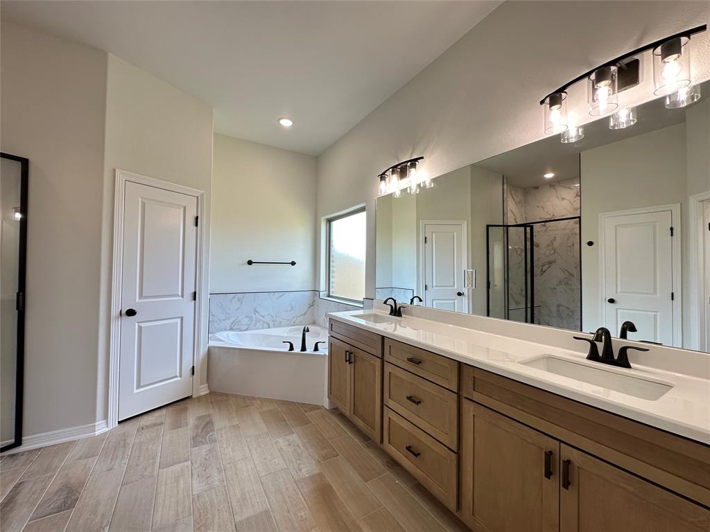 403 Rusty Spur Lorena, TX 76655 - Photo 21 of 29 a spacious bathroom with a double vanity sink a mirror and a bathtub