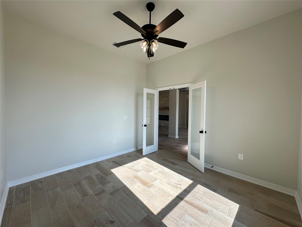 403 Rusty Spur Lorena, TX 76655 - Photo 8 of 29 a view of an empty room with a ceiling fan and a window