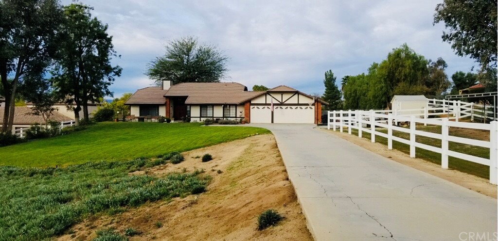 18085 Shady Side Lane Riverside, CA 92504 - Photo 1 of 1 a view of house with garden and trees