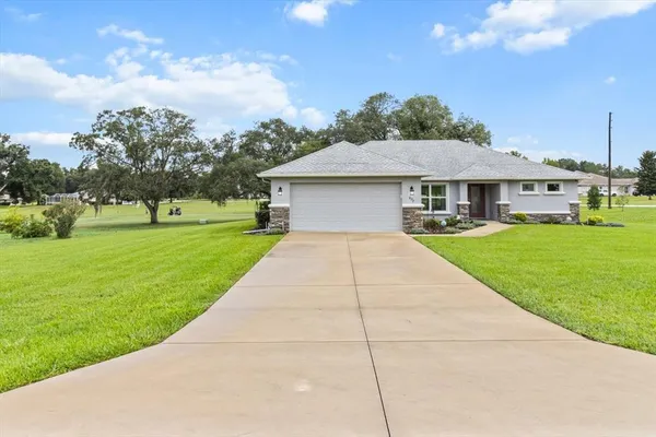 a front view of house with a garden