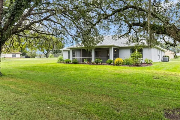 a big yard with lots of green space and trees