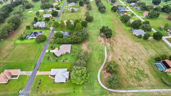 an aerial view of a house with a garden and swimming pool