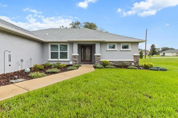 a front view of a house with a yard
