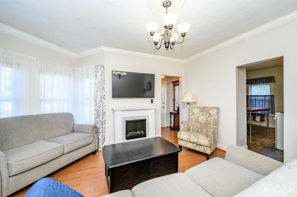 105 New Market Road Dunellen, NJ 08812 - Photo 13 of 39 a living room with furniture a fireplace and a flat screen tv
