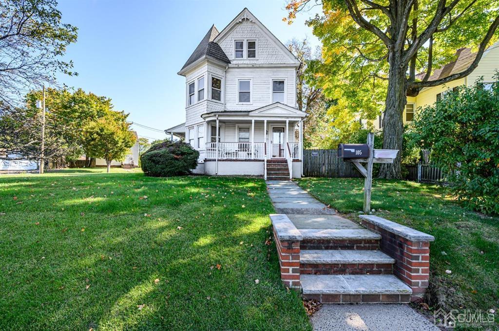 105 New Market Road Dunellen, NJ 08812 - Photo 16 of 39 a front view of a house with a yard