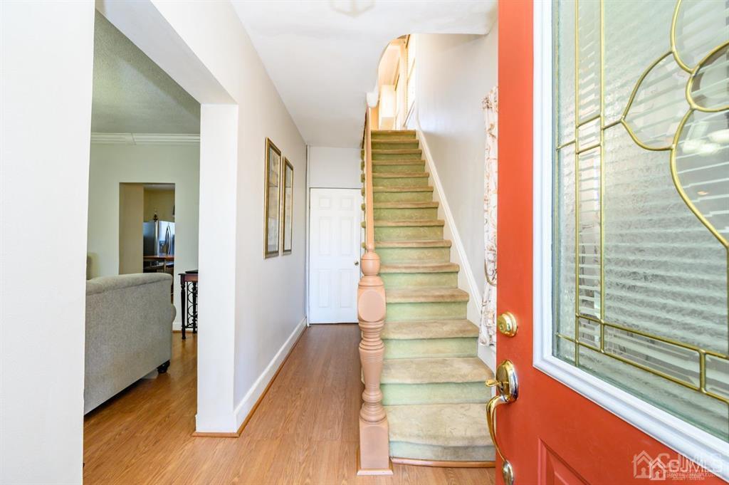 105 New Market Road Dunellen, NJ 08812 - Photo 18 of 39 a view of a hallway with wooden floor and staircase