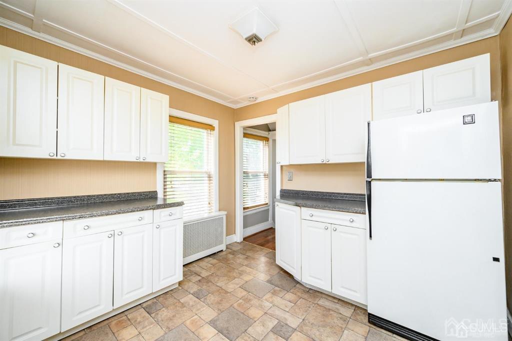 105 New Market Road Dunellen, NJ 08812 - Photo 20 of 39 a kitchen with granite countertop white cabinets and white appliances