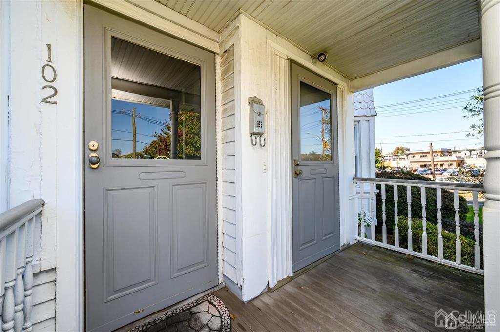 105 New Market Road Dunellen, NJ 08812 - Photo 2 of 39 a view of a hallway with wooden floor and a glass door