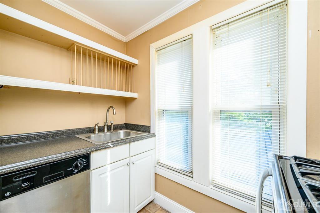 105 New Market Road Dunellen, NJ 08812 - Photo 21 of 39 a kitchen with a sink cabinets and a stove top oven