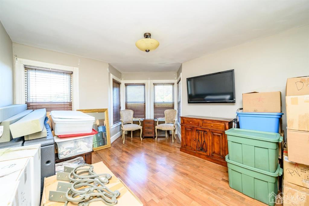 105 New Market Road Dunellen, NJ 08812 - Photo 24 of 39 a living room with furniture and a flat screen tv