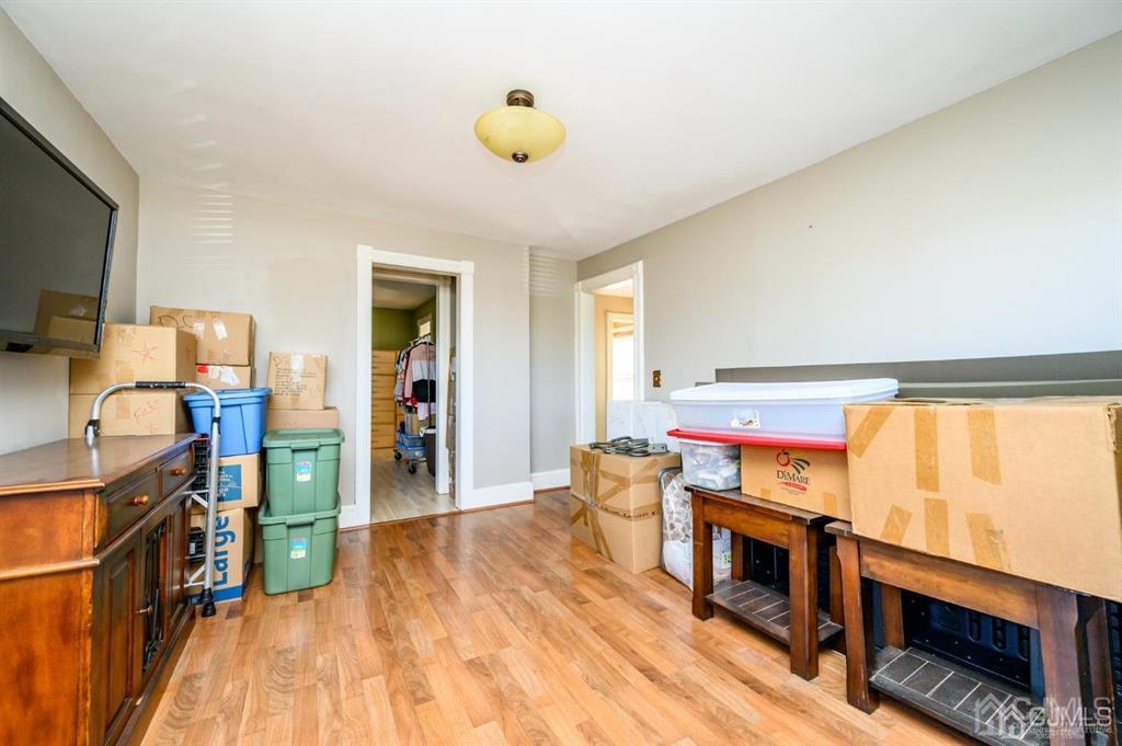 105 New Market Road Dunellen, NJ 08812 - Photo 25 of 39 a room with wooden floor and furniture