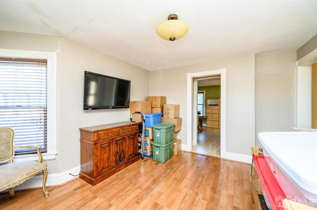 105 New Market Road Dunellen, NJ 08812 - Photo 26 of 39 a living room with furniture and a flat screen tv