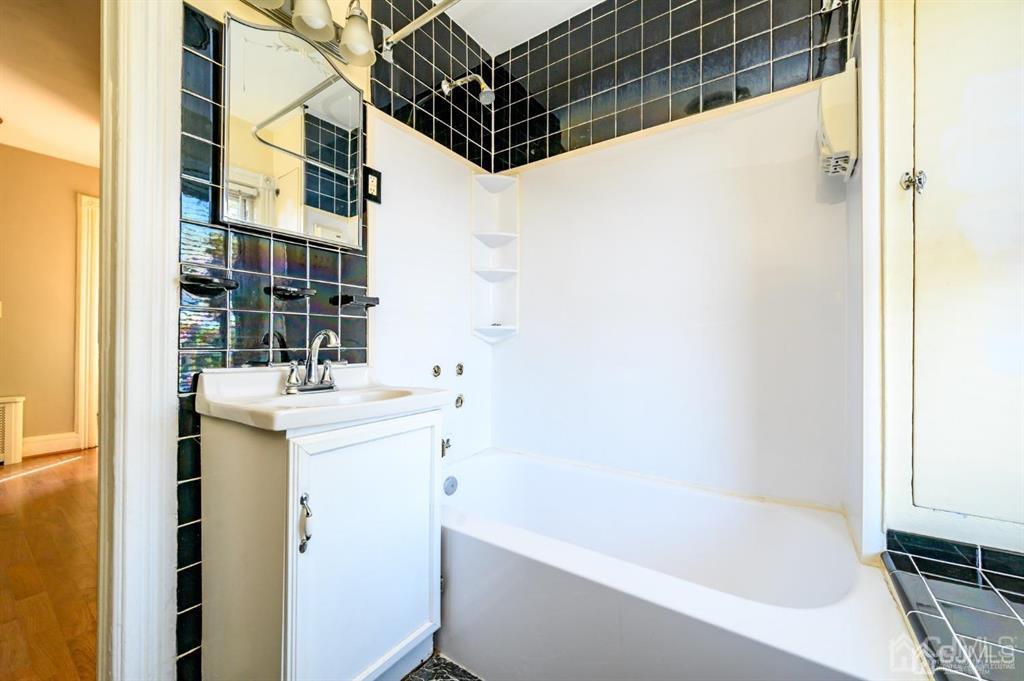 105 New Market Road Dunellen, NJ 08812 - Photo 27 of 39 a bathroom with a sink and a bathtub