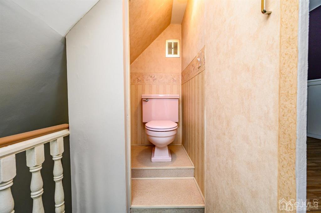 105 New Market Road Dunellen, NJ 08812 - Photo 30 of 39 a bathroom with a toilet and a shower curtain