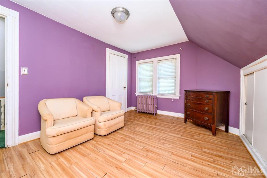 105 New Market Road Dunellen, NJ 08812 - Photo 32 of 39 a spacious bedroom with a bed and a couch