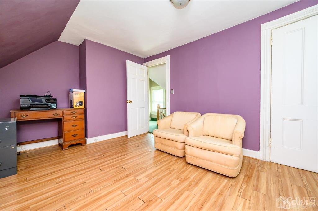 105 New Market Road Dunellen, NJ 08812 - Photo 34 of 39 a living room with furniture and wooden floor