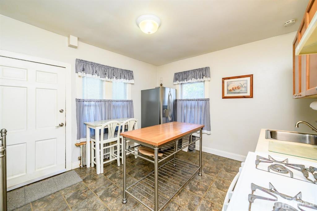 105 New Market Road Dunellen, NJ 08812 - Photo 4 of 39 a room with furniture and a table