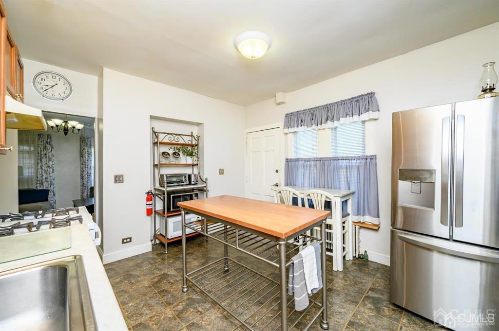 105 New Market Road Dunellen, NJ 08812 - Photo 6 of 39 a kitchen with a refrigerator a stove a sink and a refrigerator