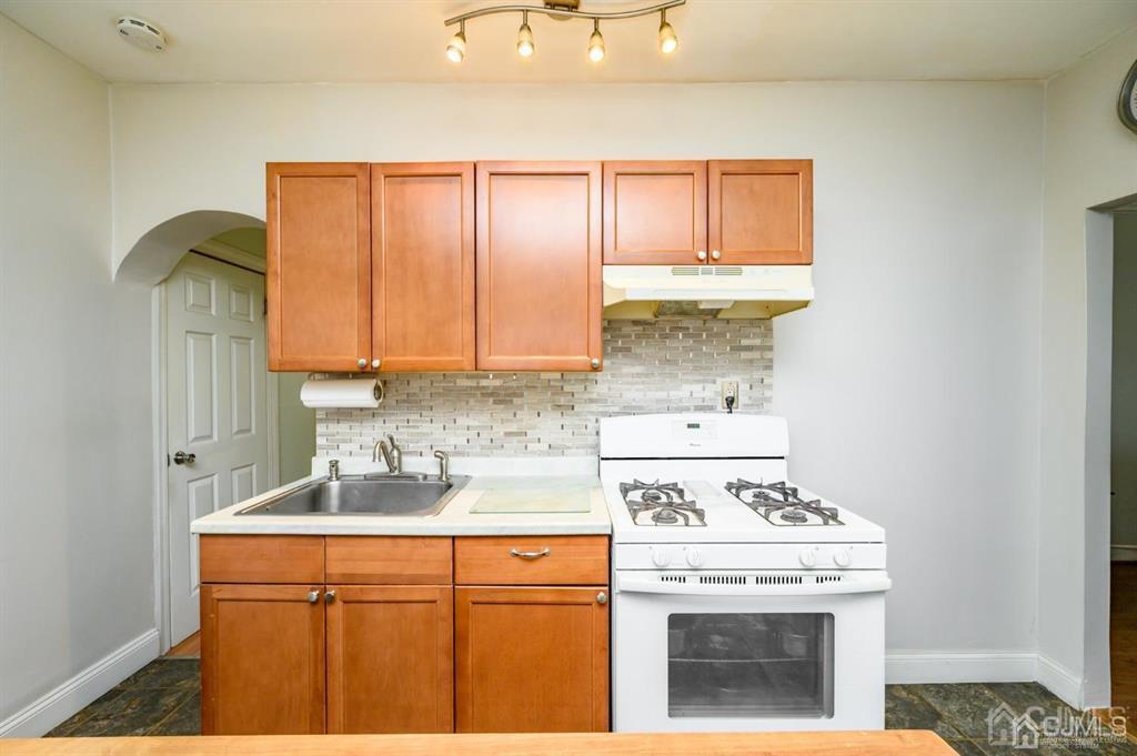 105 New Market Road Dunellen, NJ 08812 - Photo 7 of 39 a view of a kitchen with sink and washing machine