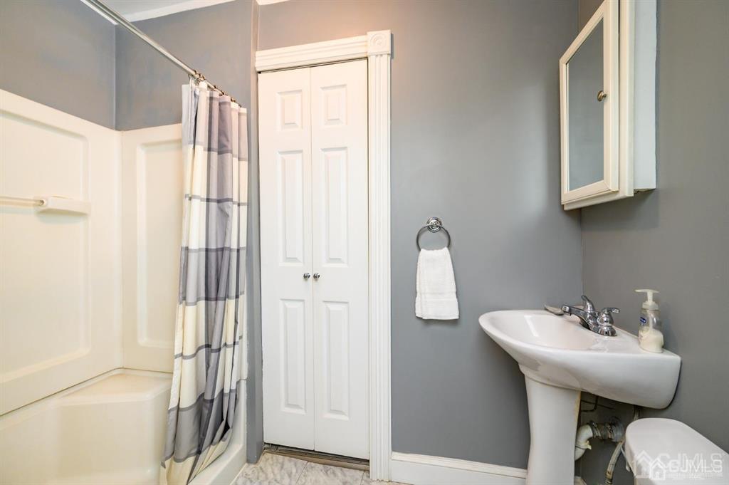 105 New Market Road Dunellen, NJ 08812 - Photo 8 of 39 a bathroom with a sink a toilet and shower