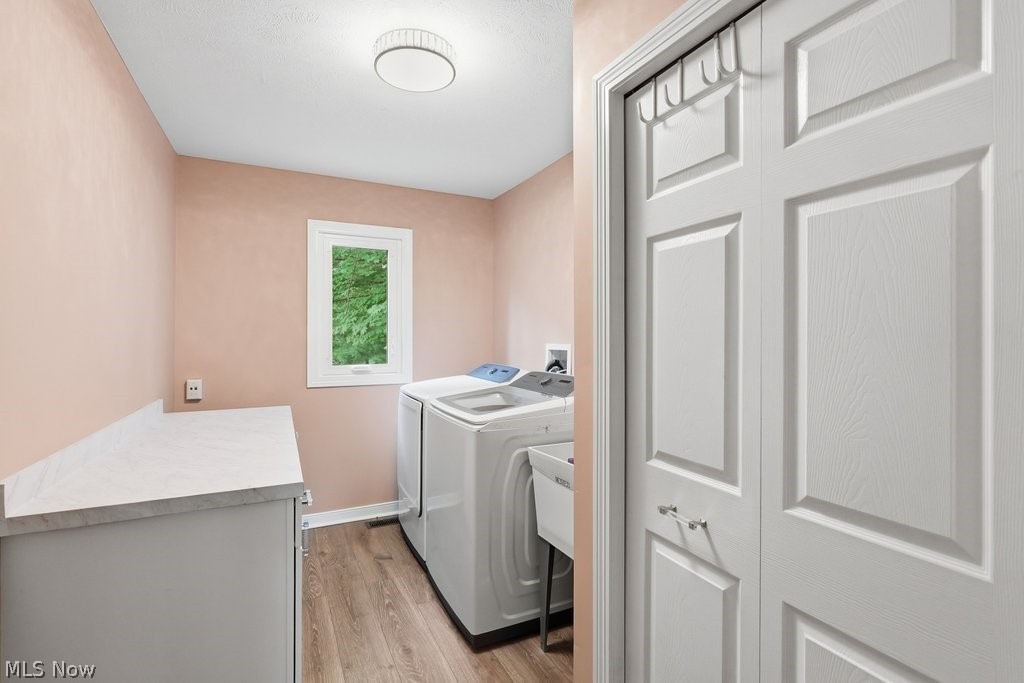 2323 Call Road Stow, OH 44224 - Photo 37 of 42 Dedicated laundry area with wood-finish flooring, a white paneled closet, and a window providing natural light
