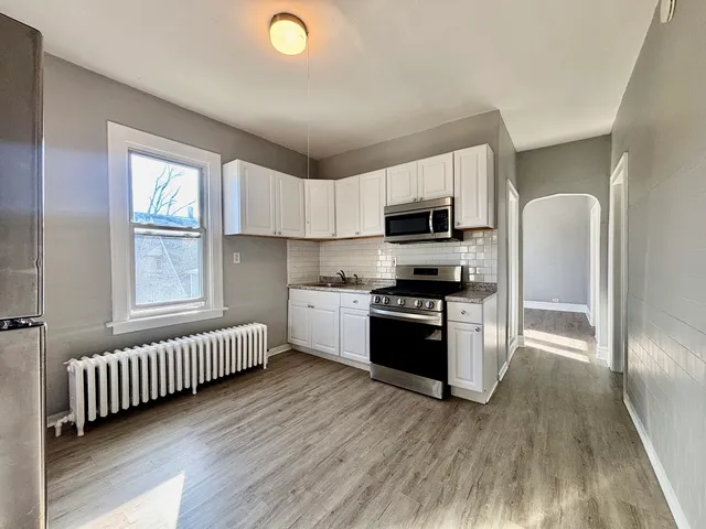 a kitchen with stainless steel appliances a microwave a stove a sink dishwasher a refrigerator and a microwave