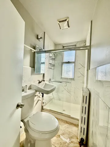 a bathroom with a sink toilet and shower