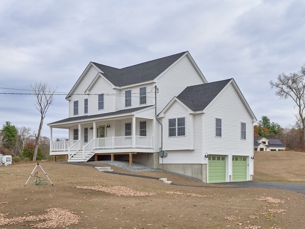 187 North End Road Townsend, MA 01469 - Photo 26 of 30 a view of a white house with large windows and a small yard