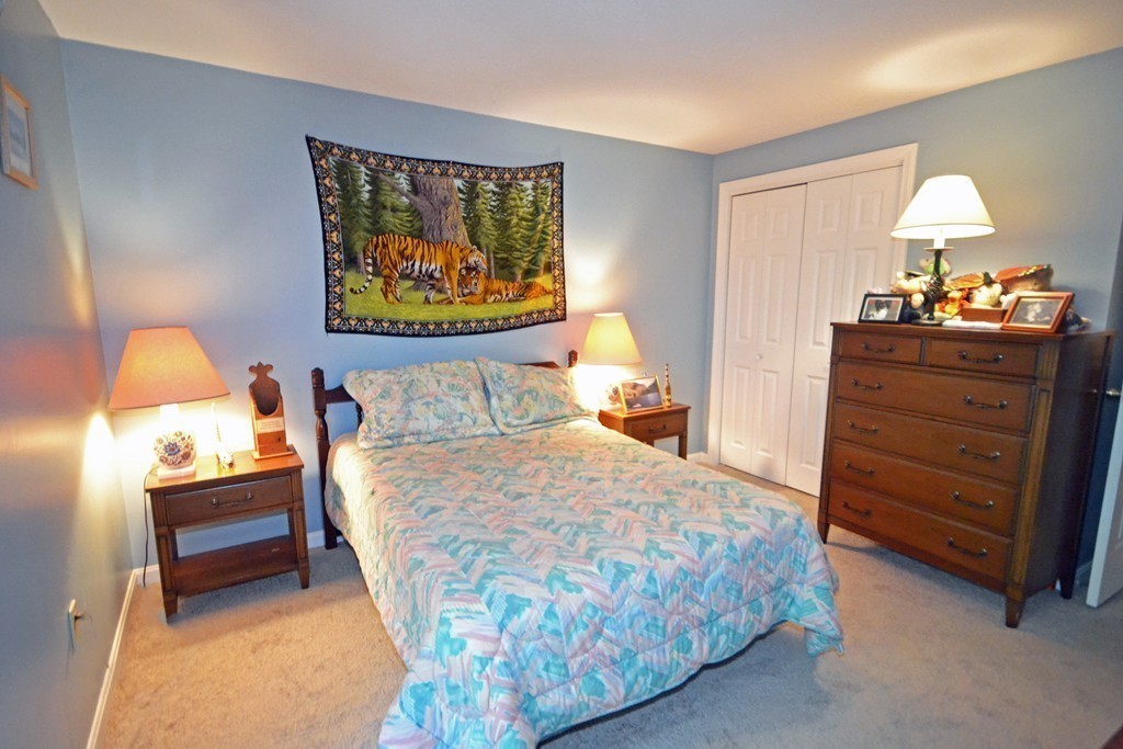 9 Ledgewood Way, Unit 2 Peabody, MA 01960 - Photo 12 of 22 a bed sitting in a bedroom and dresser