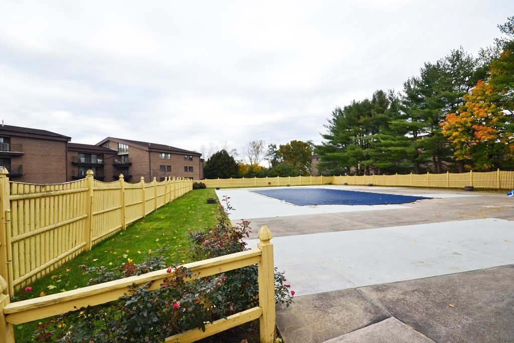 9 Ledgewood Way, Unit 2 Peabody, MA 01960 - Photo 21 of 22 a view of a yard with wooden fence