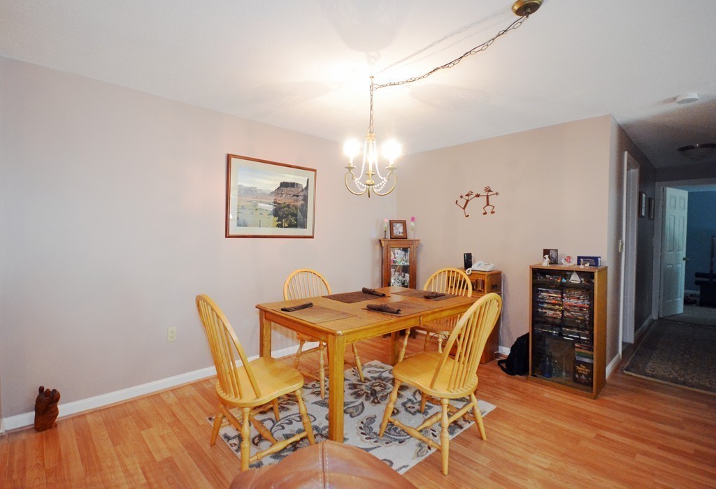 9 Ledgewood Way, Unit 2 Peabody, MA 01960 - Photo 4 of 22 a view of a dining room with furniture and wooden floor