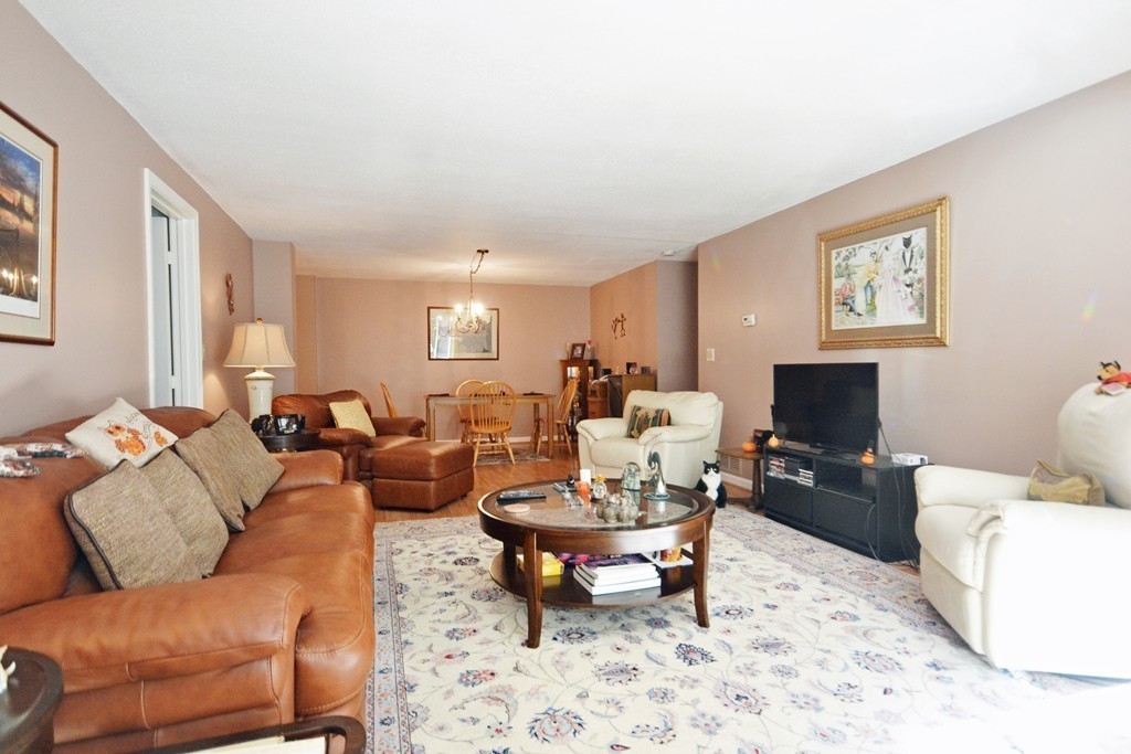 9 Ledgewood Way, Unit 2 Peabody, MA 01960 - Photo 5 of 22 a living room with furniture a rug and a flat screen tv
