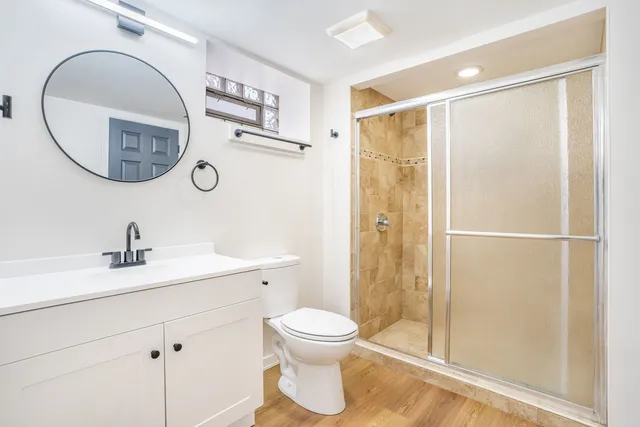a bathroom with a toilet a sink and a mirror