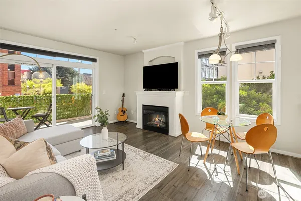 a living room with furniture a fireplace and a flat screen tv