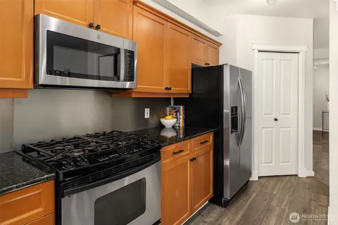 a kitchen with stainless steel appliances granite countertop a stove and a microwave